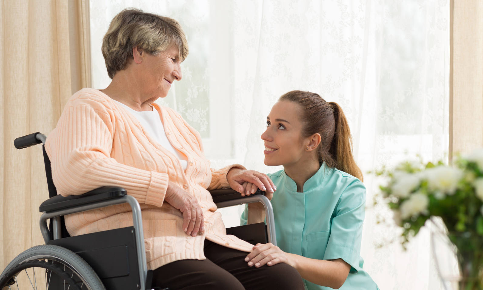 caregiver-with-woman-wheelchair-cropped