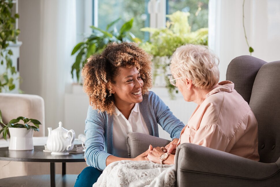 female caregiver elderly woman smiling