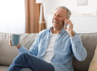 cheerful senior man talking on cell phone